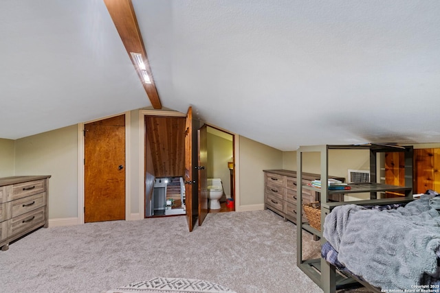 carpeted bedroom with vaulted ceiling with beams and baseboards