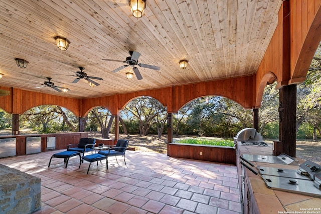 view of patio / terrace with ceiling fan, an outdoor hangout area, and exterior kitchen