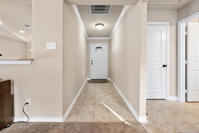 hallway featuring baseboards, ornamental molding, visible vents, and light tile patterned floors