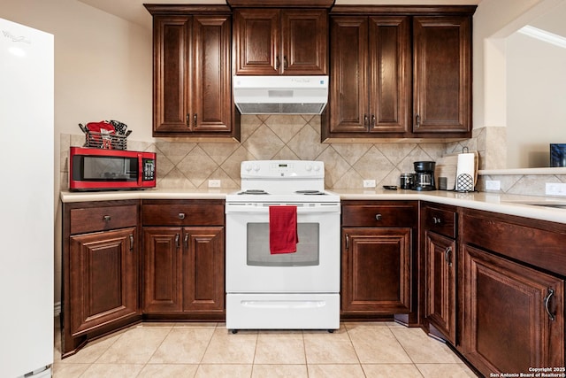 kitchen featuring light tile patterned flooring, electric stove, light countertops, and exhaust hood