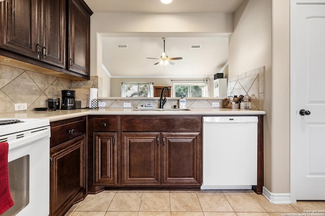 kitchen featuring a ceiling fan, a sink, decorative backsplash, and white appliances