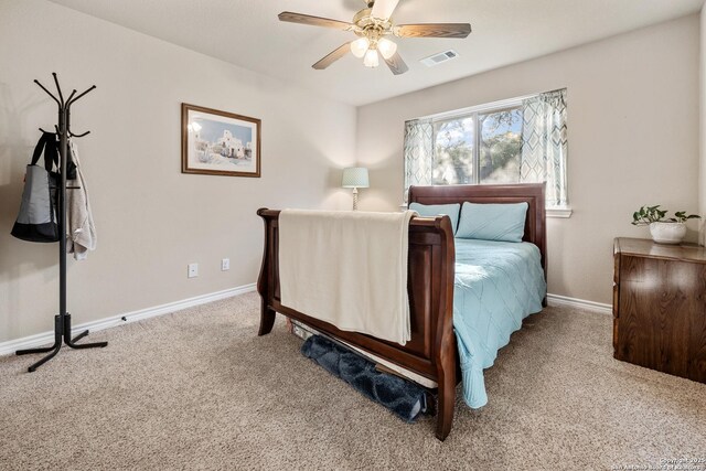 carpeted bedroom with a ceiling fan, baseboards, and visible vents