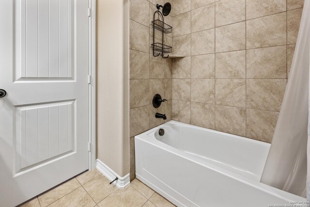 full bathroom with tile patterned flooring, baseboards, and shower / tub combo with curtain
