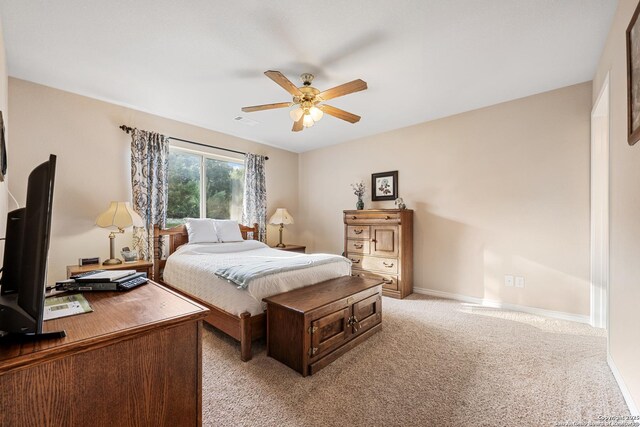 bedroom featuring baseboards, ceiling fan, visible vents, and light carpet