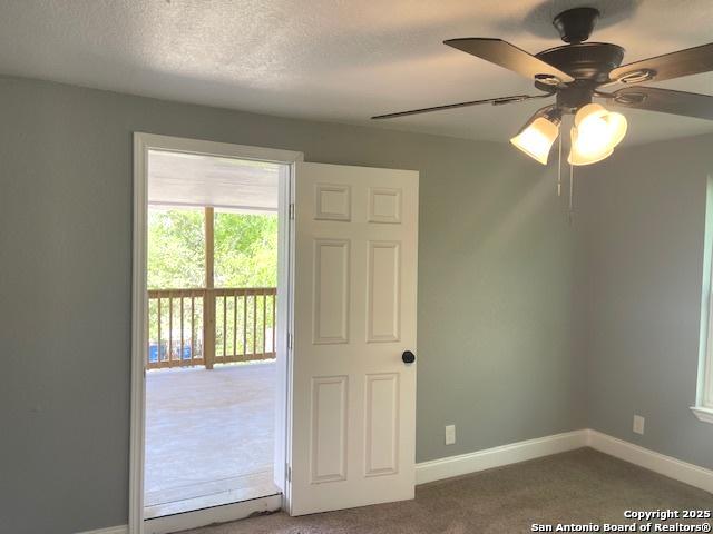 2215 Saint Anthony, San Antonio, TX 78210 - carpeted empty room with baseboards, a ceiling fan, and a textured ceiling