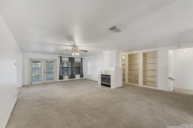 2343 Country Grace, New Braunfels, TX 78130 - unfurnished living room with carpet flooring, a fireplace, visible vents, and a ceiling fan