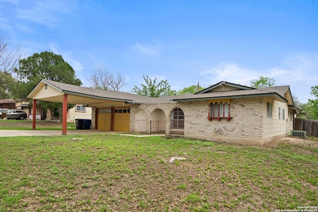 ranch-style home with concrete driveway, an attached garage, a front yard, brick siding, and fence
