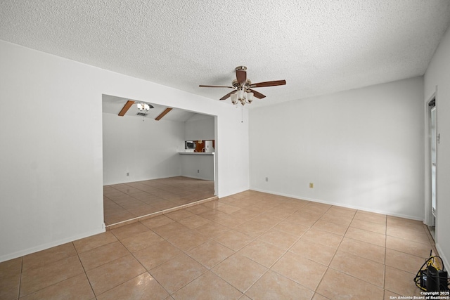 unfurnished living room with a textured ceiling, ceiling fan, and light tile patterned floors