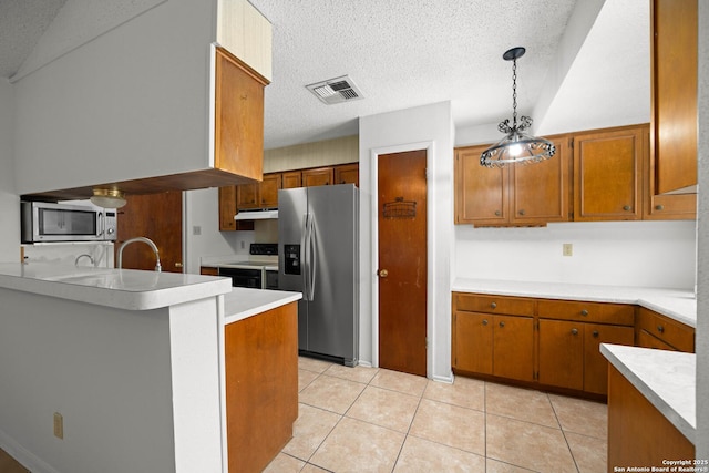 kitchen featuring visible vents, light countertops, appliances with stainless steel finishes, under cabinet range hood, and brown cabinets