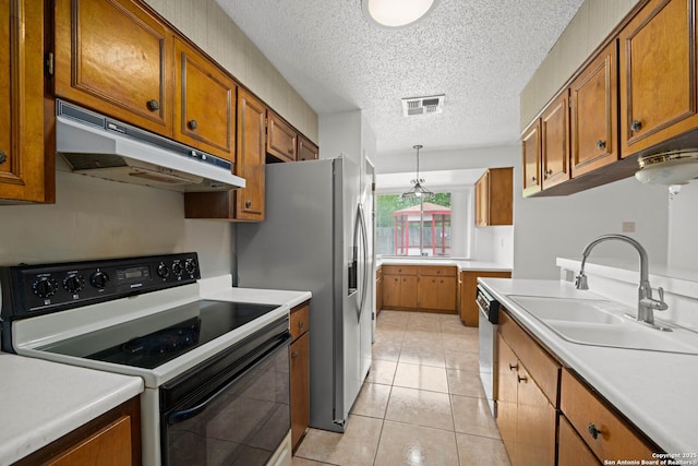 kitchen with brown cabinetry, electric range, under cabinet range hood, and a sink