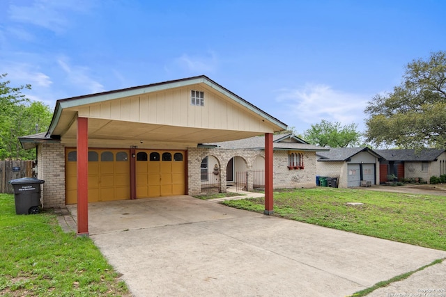 view of front of house featuring a front yard, driveway, brick siding, and a carport