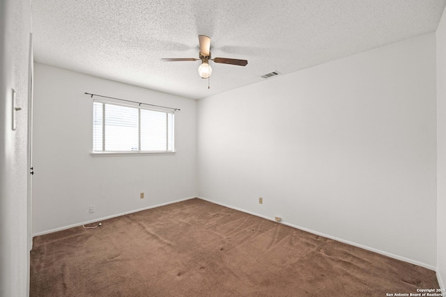 carpeted empty room with visible vents, ceiling fan, baseboards, and a textured ceiling