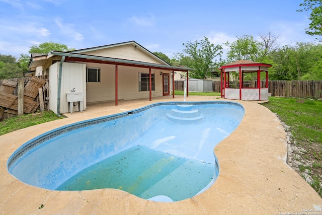 view of swimming pool featuring a fenced backyard, a gazebo, a fenced in pool, and a patio