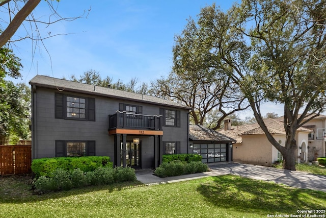 112 Coventry Ln, Terrell Hills, TX 78209 - view of front of home with concrete driveway, fence, an attached garage, a balcony, and a front yard