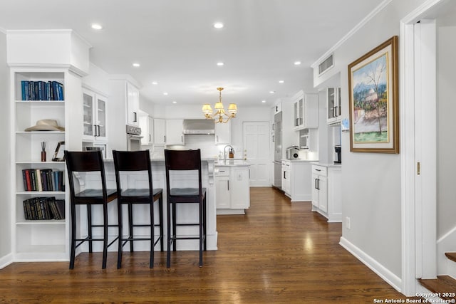 112 Coventry Ln, Terrell Hills, TX 78209 - kitchen featuring a chandelier, wall chimney exhaust hood, dark wood finished floors, glass insert cabinets, and oven