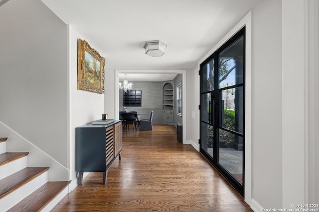 112 Coventry Ln, Terrell Hills, TX 78209 - corridor with a chandelier, baseboards, built in shelves, wood finished floors, and stairway