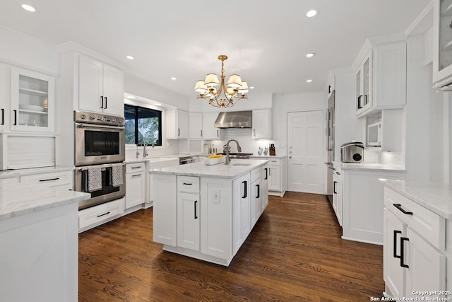 112 Coventry Ln, Terrell Hills, TX 78209 - kitchen with white cabinetry, wall chimney exhaust hood, and stainless steel double oven