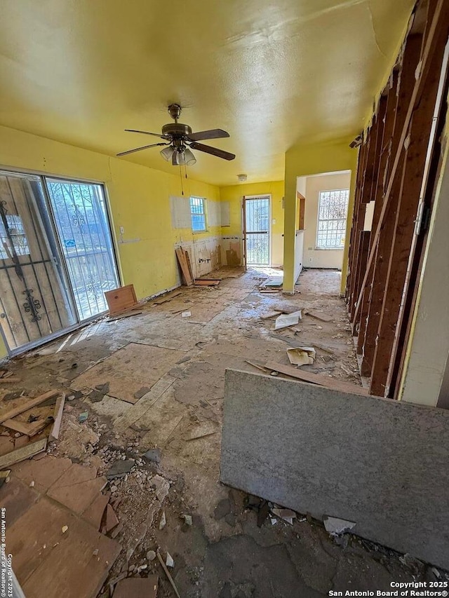 unfurnished living room featuring ceiling fan