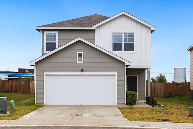 view of front facade with board and batten siding, driveway, a garage, and fence