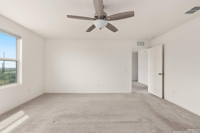 unfurnished room featuring a ceiling fan, visible vents, and carpet
