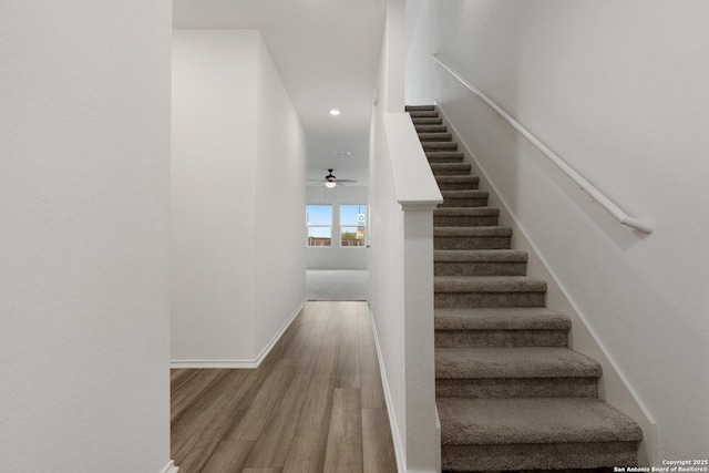 staircase with recessed lighting, baseboards, ceiling fan, and wood finished floors