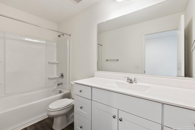 bathroom with toilet, shower / tub combination, vanity, and wood finished floors