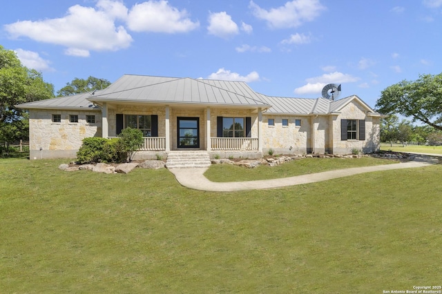 ranch-style home with a front yard, a standing seam roof, metal roof, and a porch