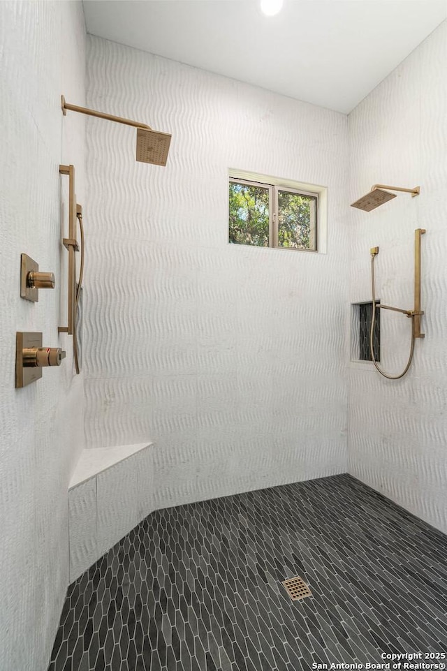 bathroom featuring a tile shower