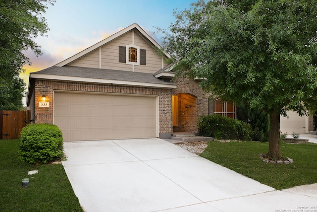 view of front facade featuring fence, concrete driveway, a garage, and brick siding