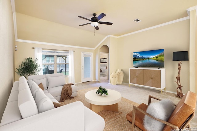 carpeted living room with arched walkways, ceiling fan, visible vents, and baseboards