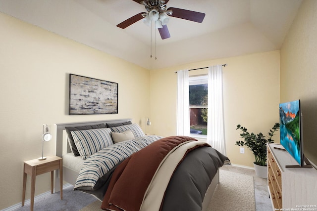 bedroom featuring baseboards, ceiling fan, and light carpet