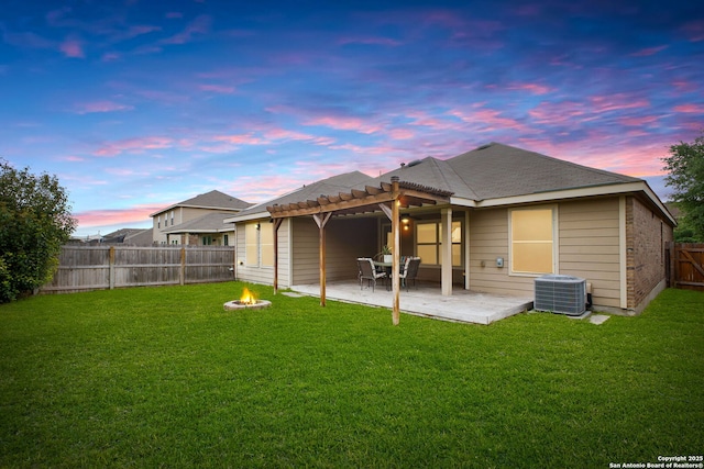 back of house with a pergola, central air condition unit, a fenced backyard, a lawn, and a fire pit