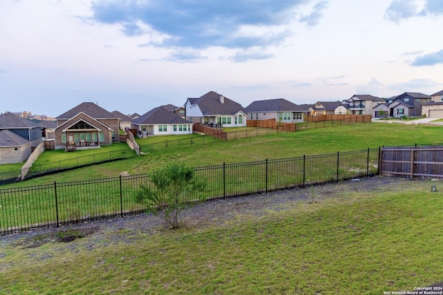 view of yard with a fenced backyard and a residential view
