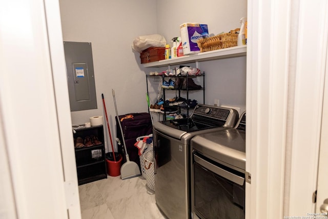 laundry room with electric panel, washer and clothes dryer, marble finish floor, and laundry area