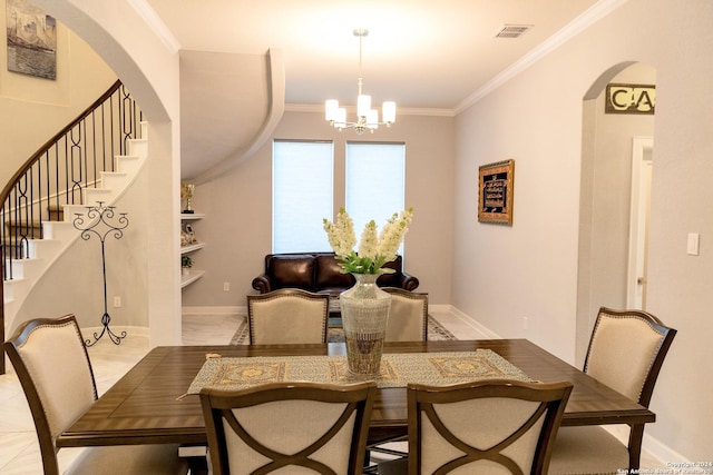 dining space with visible vents, arched walkways, ornamental molding, and a chandelier