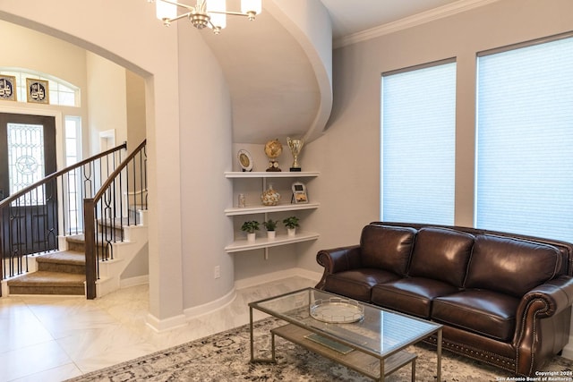 living area with stairs, a notable chandelier, baseboards, arched walkways, and ornamental molding