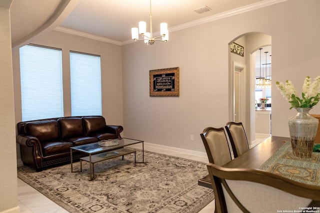 living area with visible vents, baseboards, ornamental molding, arched walkways, and a notable chandelier