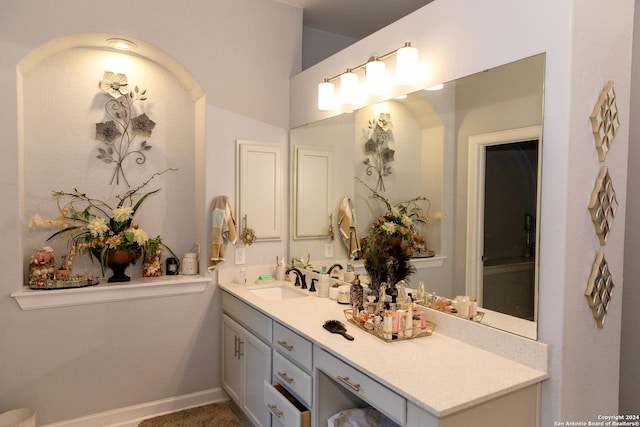 bathroom featuring baseboards and vanity