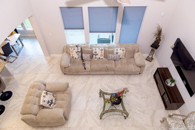 living area with marble finish floor and baseboards