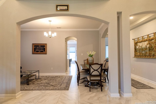 dining room featuring marble finish floor, baseboards, arched walkways, and ornamental molding