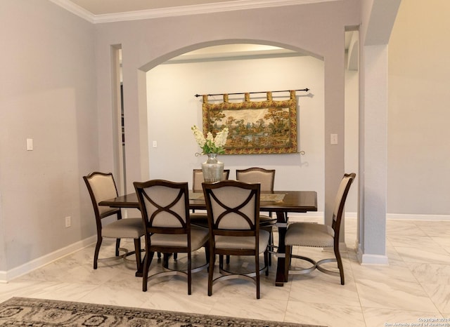 dining space with marble finish floor, baseboards, arched walkways, and ornamental molding