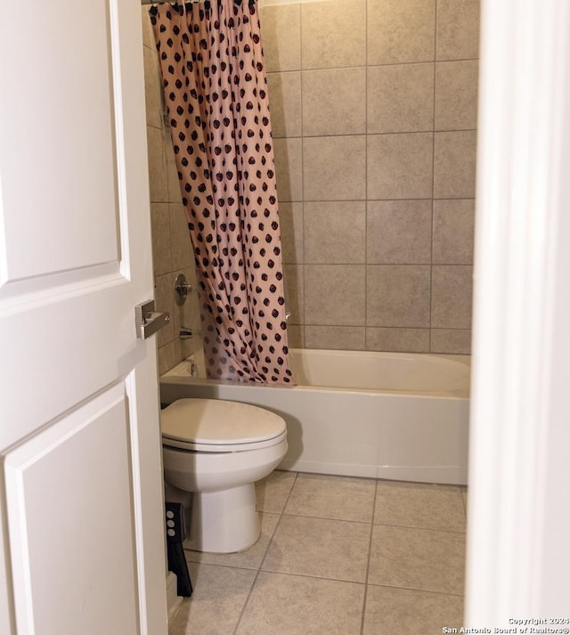 bathroom with shower / bath combo, toilet, and tile patterned flooring