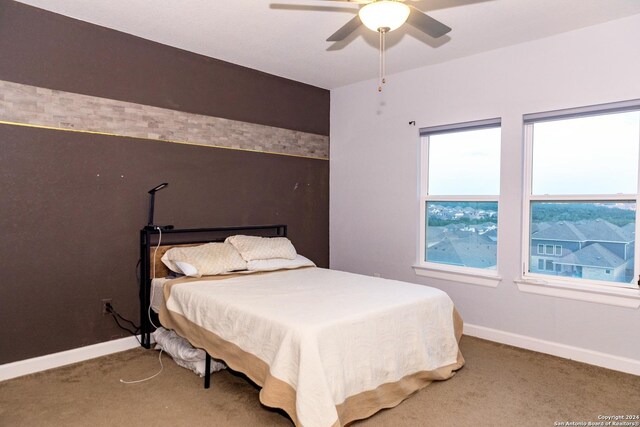 bedroom with carpet, baseboards, and ceiling fan