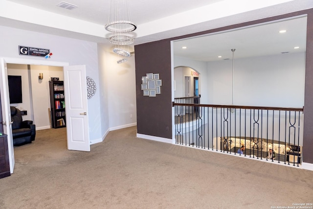 unfurnished room featuring recessed lighting, carpet, baseboards, arched walkways, and visible vents