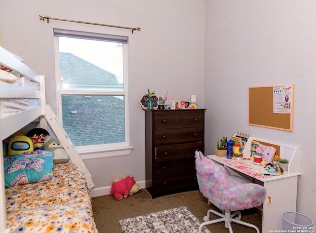 carpeted bedroom featuring baseboards