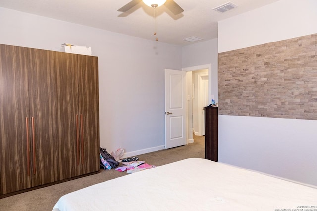 carpeted bedroom featuring visible vents and ceiling fan