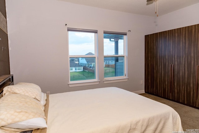 bedroom with baseboards and carpet floors