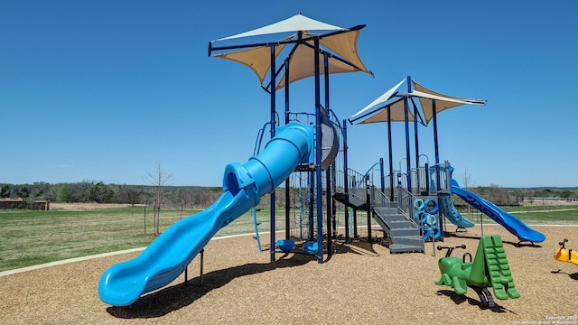 community jungle gym featuring a yard