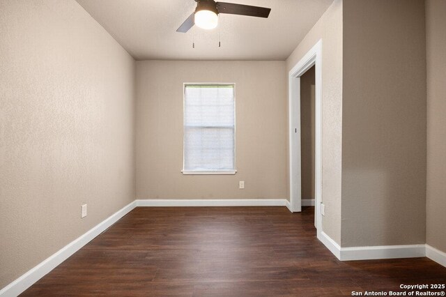spare room with a ceiling fan, baseboards, and wood finished floors