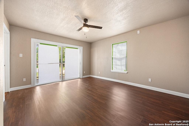 spare room featuring wood finished floors, a textured ceiling, baseboards, and ceiling fan